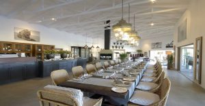Long dining table prepared for guests at Mushara Outpost