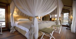 Mosquito-netted bed inside a Mushara safari tent