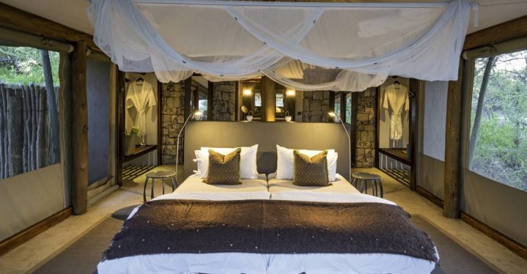 Onguma Tented Camp – luxury tent bedroom with mosquito net