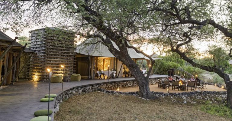 tented accommodation near Etosha – main lodge and fire pit beneath trees