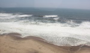 Terrace Bay Namibia – aerial view of surf meeting the desert