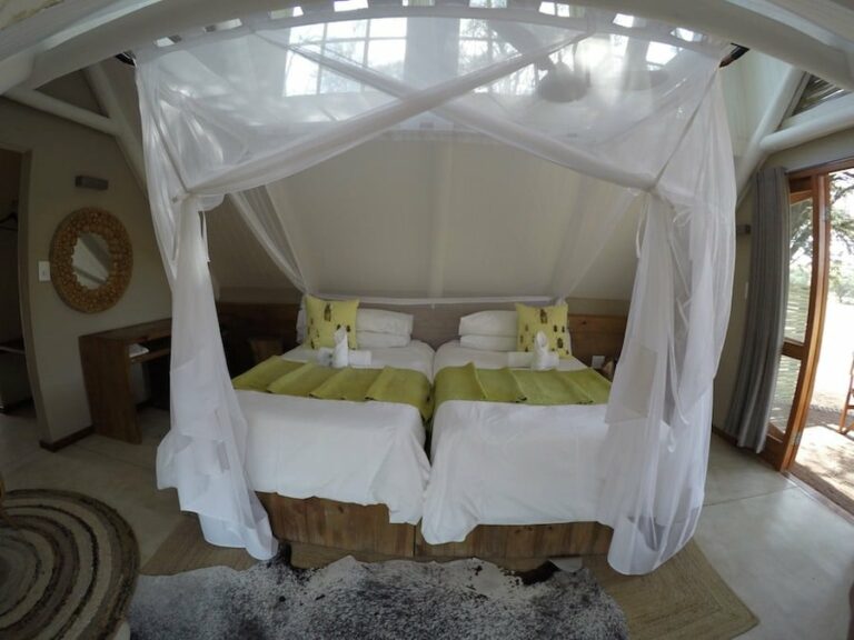 Auob River accommodation – twin beds beneath mosquito nets