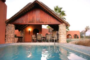 Mount Etjo Safari Lodge – pool and timber chalet exterior