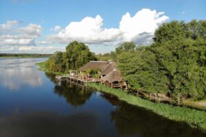 Okavango River lodge – riverfront lodge surrounded by green trees