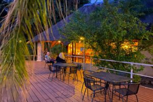 Divundu accommodation – outdoor tables on the wooden river deck