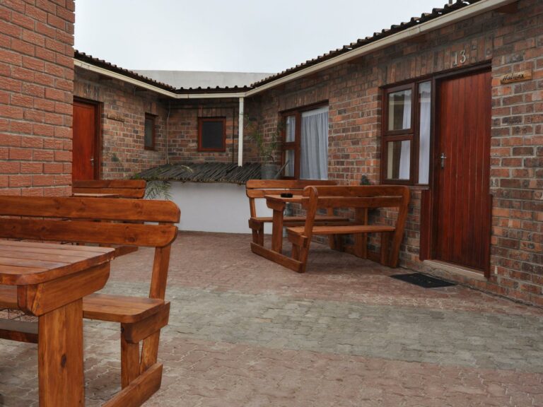 Obelix Guesthouse – brick patio outside guest rooms