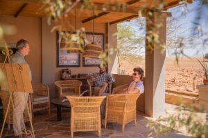 Wolwedans Namibia – guests relaxing on the lodge veranda