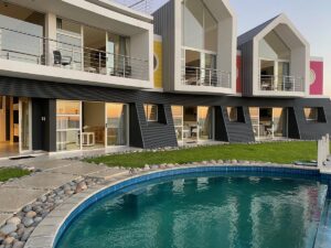 Swakopmund beachfront guesthouse – landscaped pool area beneath sea-view rooms
