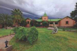Garden and lodge buildings at Canyon Lodge accommodation