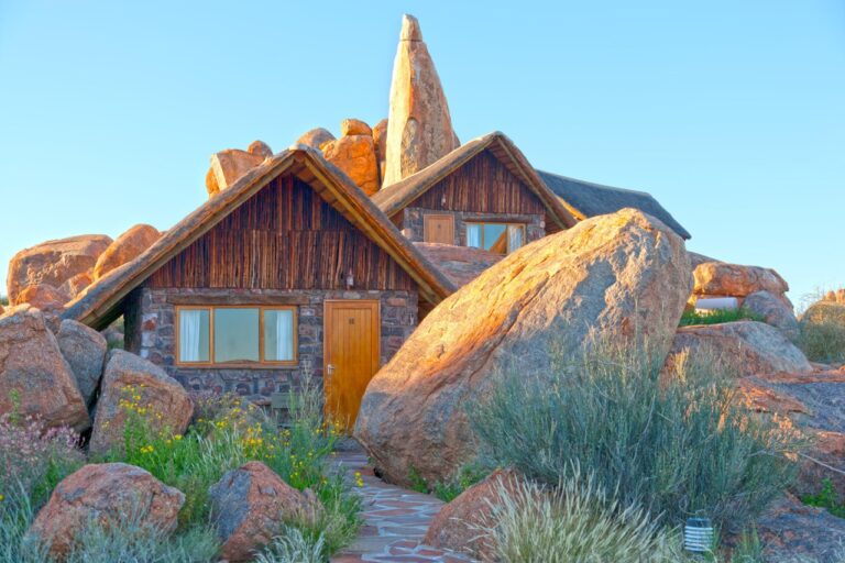 Stone-and-thatch Canyon Lodge chalets among granite boulders