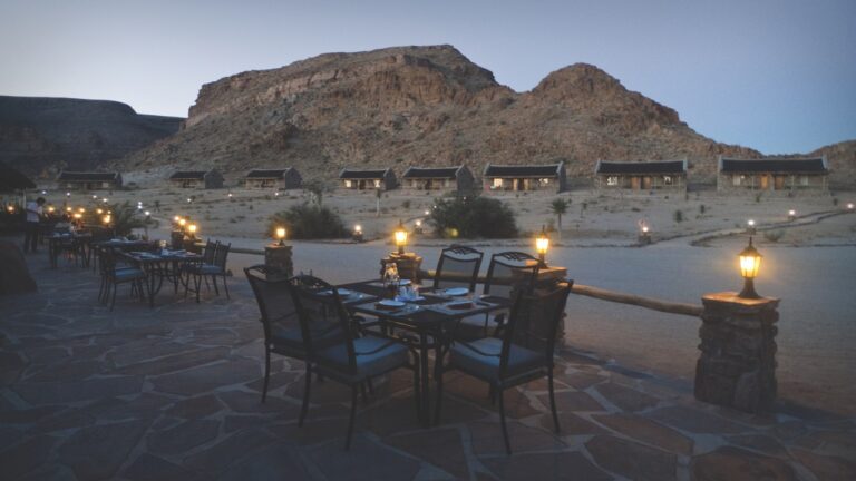 Outdoor dining terrace at Canyon Village after sunset