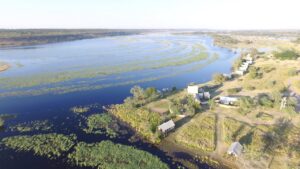 Aerial view of Chobe River Camp beside the river and floodplains
