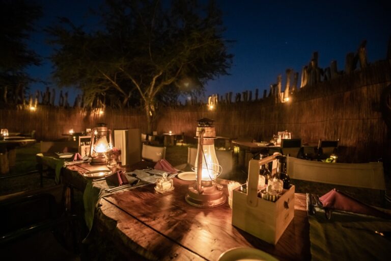 Lantern-lit outdoor dining table at Chobe River Camp