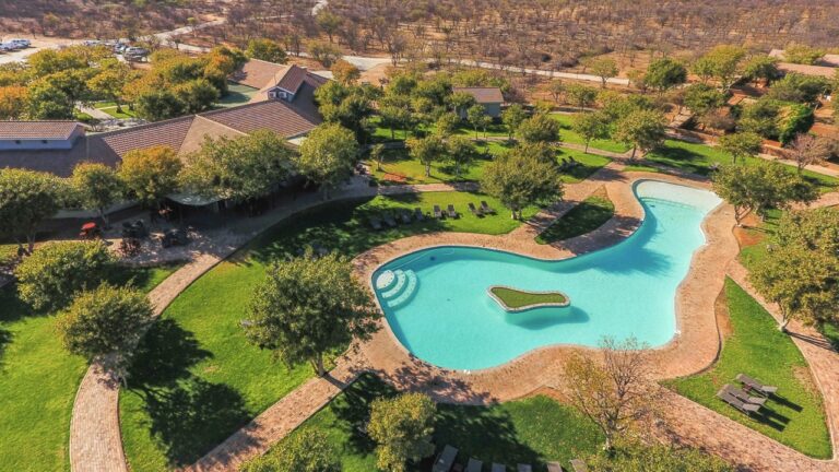 Aerial view of Damara Mopane Lodge chalets and swimming pool