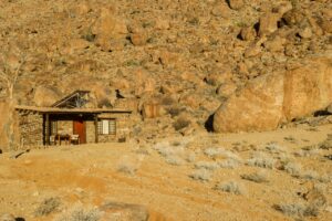 Stone chalet built among granite boulders near Aus