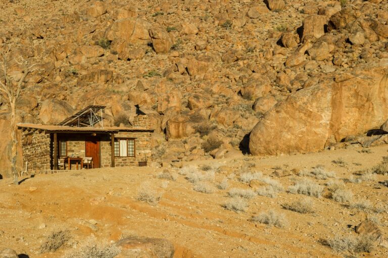 Stone chalet built among granite boulders near Aus