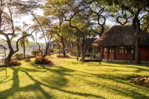 Shaded gardens and chalets at Hakusembe River Lodge