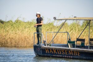 Guest fishing from a Hakusembe River Lodge boat