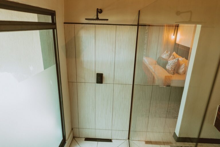 Walk-in shower in a Namushasha River Lodge bathroom