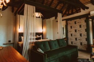 Guest room with bed and green sofa at the lodge