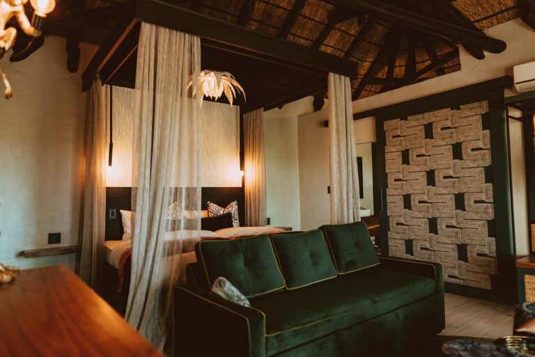 Guest room with bed and green sofa at the lodge