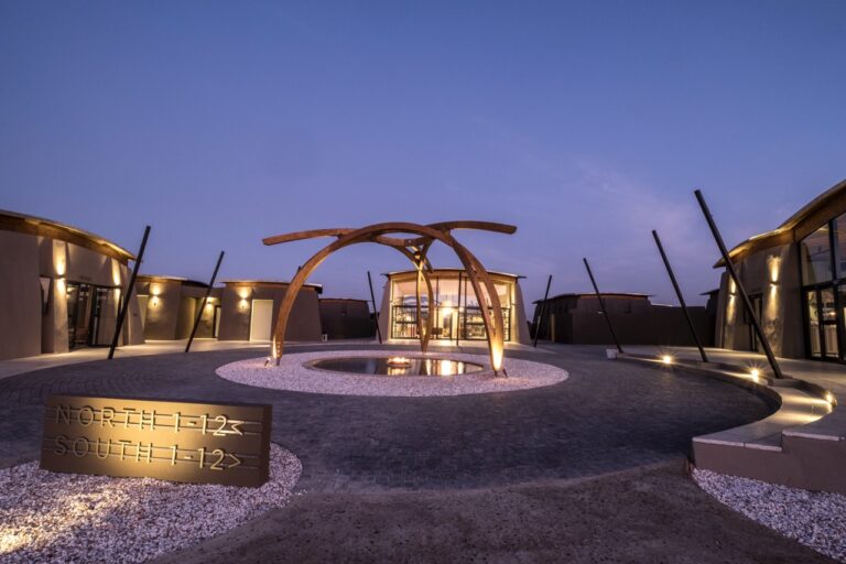Pink-lit entrance area at The Desert Grace