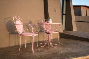 Pink patio furniture outside The Desert Grace