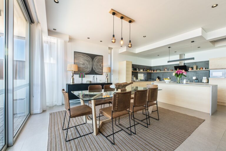 Dining table and kitchen at The Pearls Beach Pods