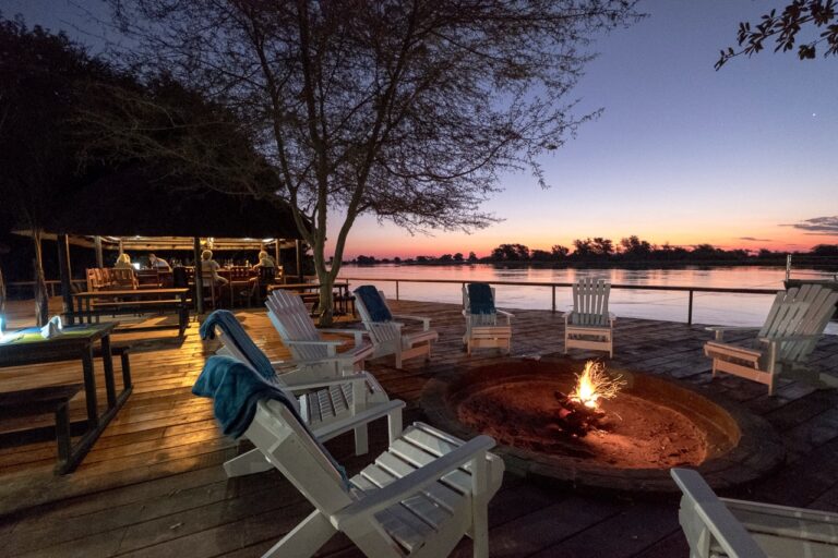 Fire pit on the riverside deck at Zambezi Mubala Camp after sunset