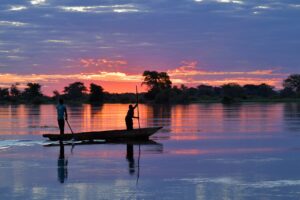Traditional canoe on the Zambezi River near Zambezi Mubala Lodge at sunset
