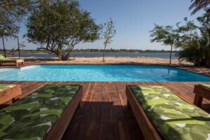 Swimming pool and river deck at Zambezi Mubala Lodge