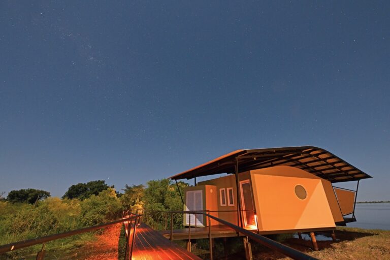 Riverfront bungalow at Zambezi Mubala Lodge after sunset