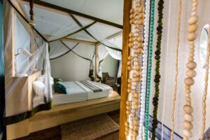 Mosquito-netted bed in a Zambezi Mubala Lodge room