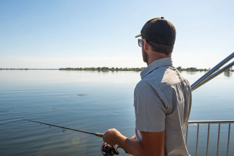 Guest fishing from a boat near Zambezi Mubala Lodge