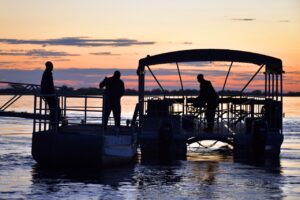 Boat cruise departing Zambezi Mubala Lodge at sunset