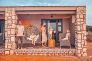 Family outside a Kalahari Anib Lodge room