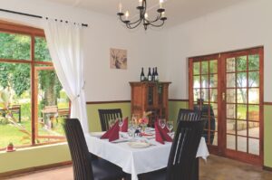 Restaurant table beside the garden at Kalahari Farmhouse